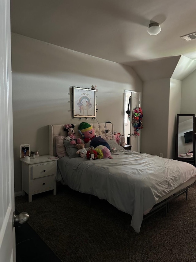 bedroom with lofted ceiling, visible vents, and carpet flooring