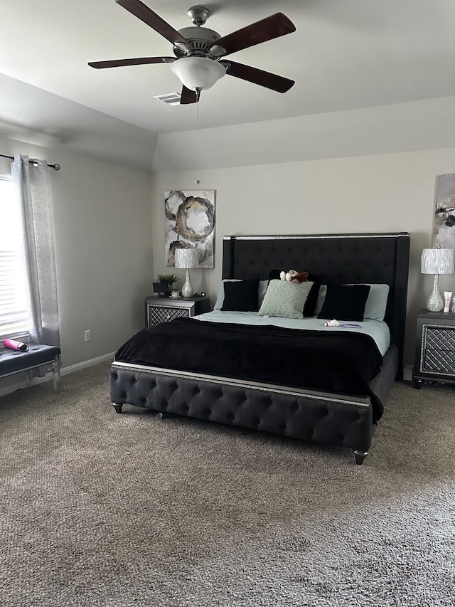 carpeted bedroom with ceiling fan and baseboards