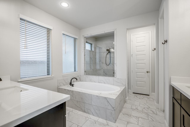 bathroom with a garden tub, recessed lighting, vanity, marble finish floor, and a marble finish shower