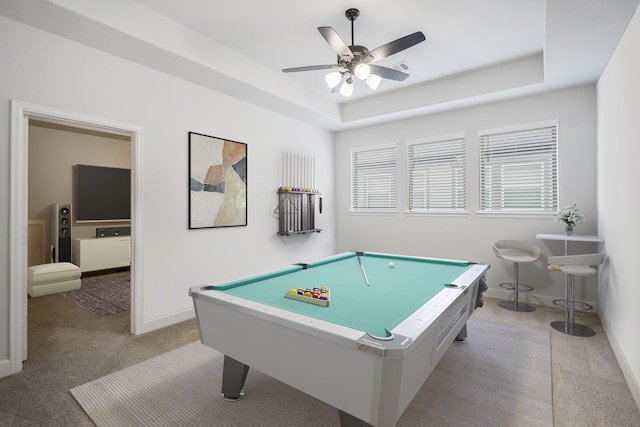 game room featuring ceiling fan, pool table, a tray ceiling, and light colored carpet