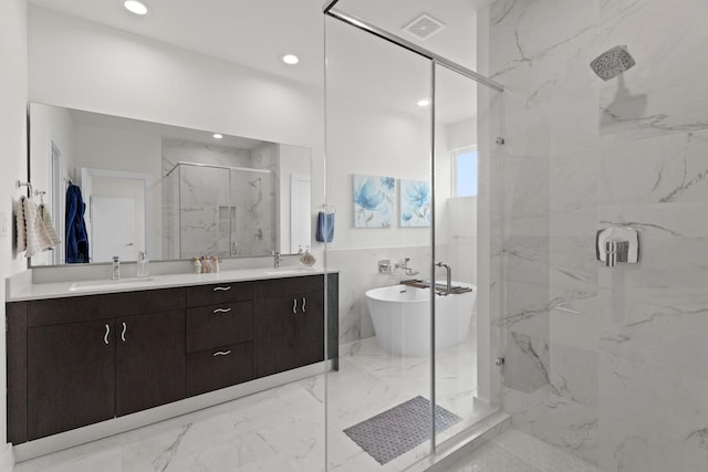 full bath featuring a sink, visible vents, a soaking tub, a marble finish shower, and double vanity