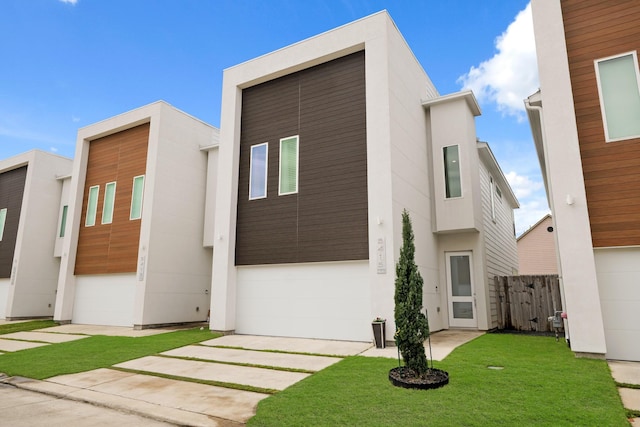 view of front of house with a front yard, fence, and stucco siding