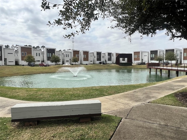 view of property's community featuring a residential view, a water view, and a yard