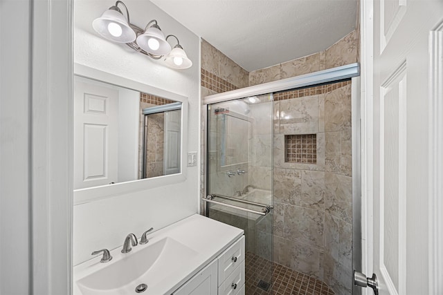 bathroom with a stall shower and vanity