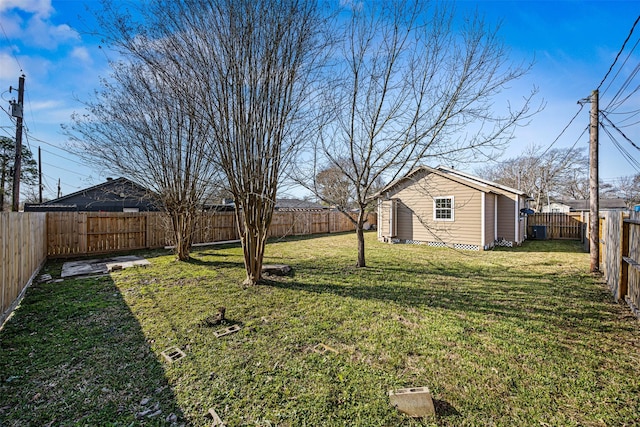 view of yard with an outdoor structure and a fenced backyard