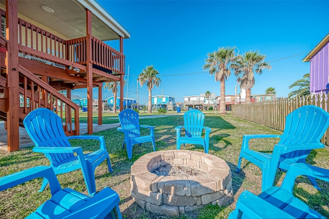 411 Olive St, Surfside Beach, TX 77541 - view of yard featuring stairway, fence, a fire pit, and a wooden deck
