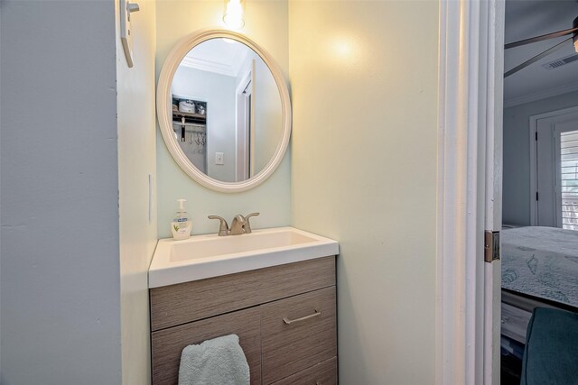 411 Olive St, Surfside Beach, TX 77541 - bathroom with ceiling fan, visible vents, crown molding, and vanity