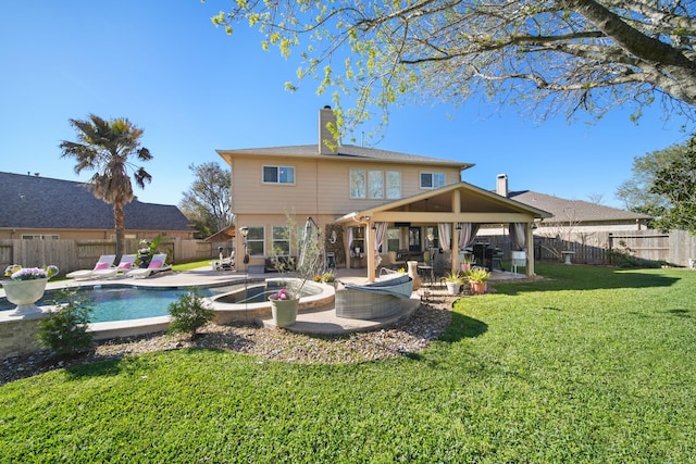 rear view of property featuring a patio, a lawn, a fenced backyard, and a fenced in pool