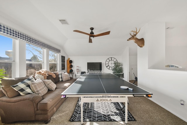 rec room with carpet, visible vents, vaulted ceiling, ceiling fan, and baseboards