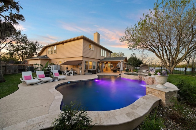 view of swimming pool with a patio area, a fenced backyard, a fenced in pool, and an in ground hot tub