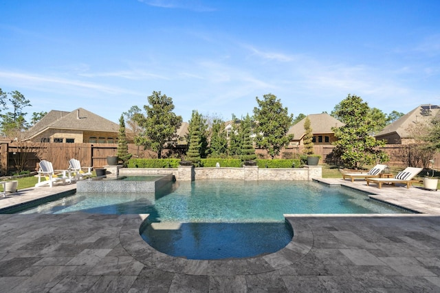 view of swimming pool with a pool with connected hot tub, a fenced backyard, and a patio