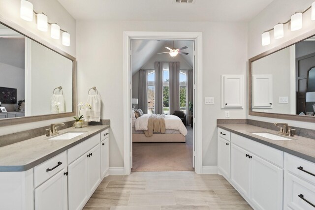 full bathroom with a sink, two vanities, and ensuite bath