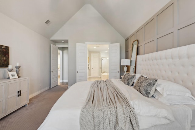 carpeted bedroom with high vaulted ceiling, visible vents, connected bathroom, and baseboards