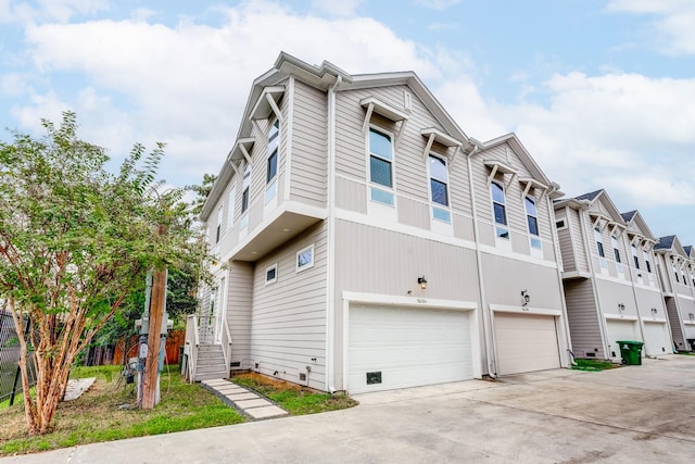 view of front facade with a garage, driveway, and a residential view