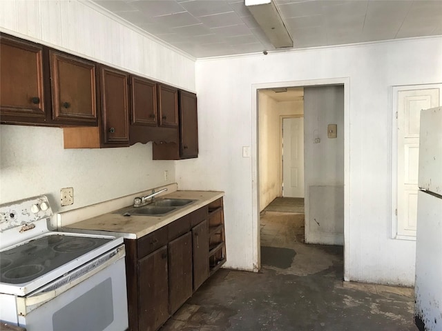 kitchen featuring white range with electric cooktop, a sink, dark brown cabinetry, light countertops, and concrete flooring