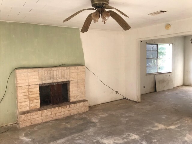 unfurnished living room featuring visible vents, a ceiling fan, concrete flooring, and a fireplace