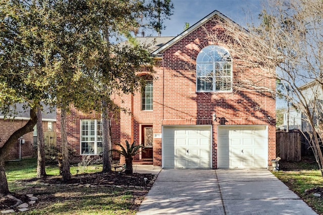 traditional-style home with an attached garage, fence, concrete driveway, and brick siding