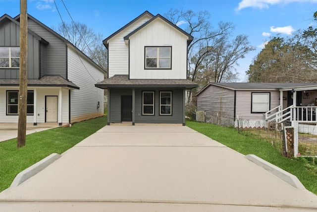 view of front facade featuring board and batten siding, a front yard, roof with shingles, and a porch