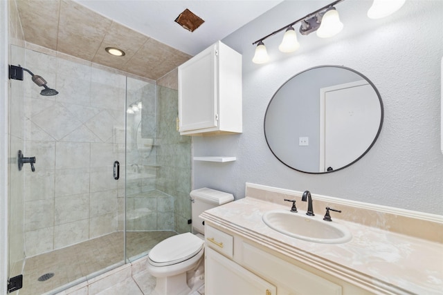 full bathroom featuring a shower stall, toilet, and vanity