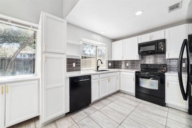 kitchen featuring open shelves, a sink, visible vents, white cabinetry, and black appliances