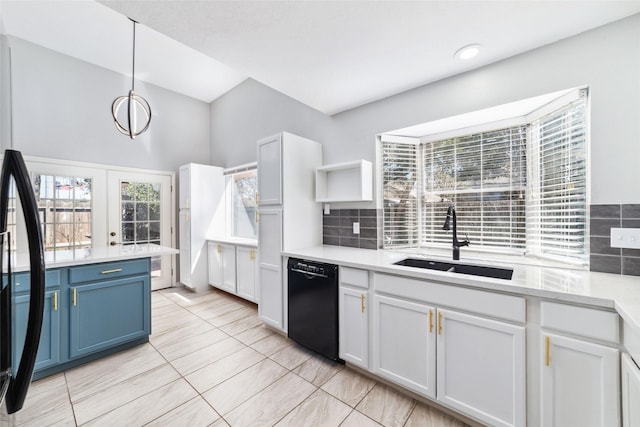 kitchen featuring blue cabinetry, tasteful backsplash, light countertops, a sink, and dishwasher