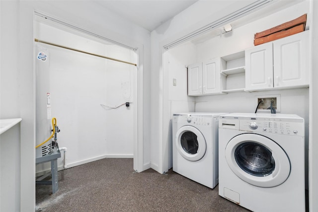 laundry room featuring cabinet space, baseboards, and separate washer and dryer