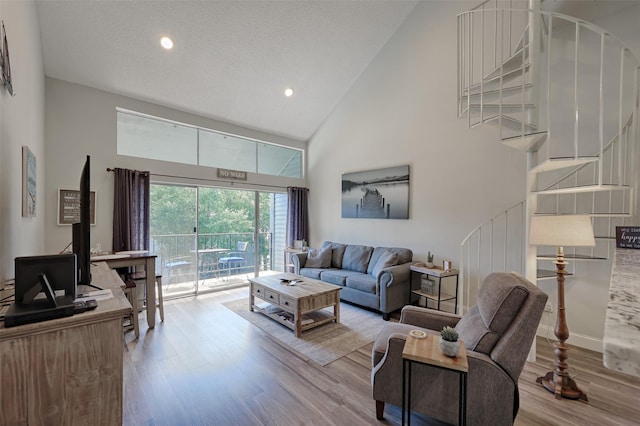 living area featuring baseboards, wood finished floors, a textured ceiling, high vaulted ceiling, and recessed lighting