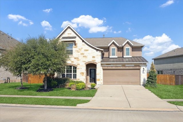 traditional home featuring metal roof, fence, concrete driveway, a standing seam roof, and a front yard