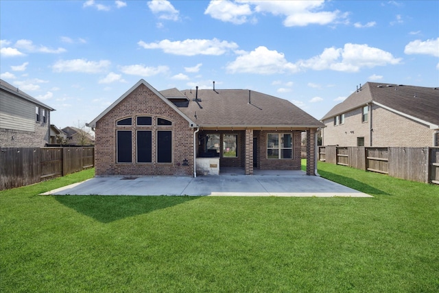 back of house with brick siding, a patio, and a lawn