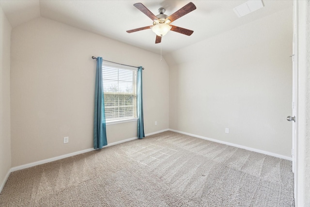 unfurnished room featuring lofted ceiling, visible vents, a ceiling fan, baseboards, and carpet