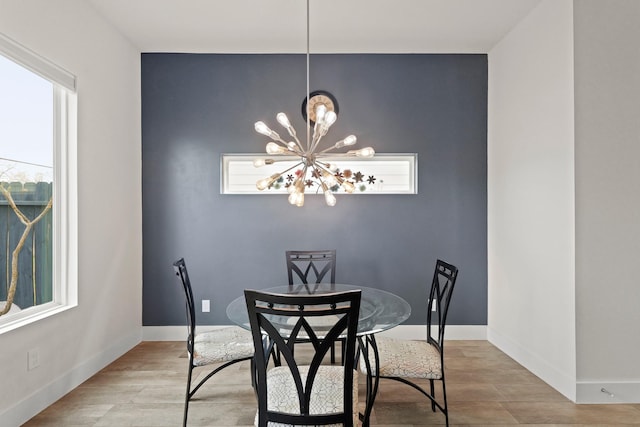 dining room featuring a notable chandelier, baseboards, and a wealth of natural light