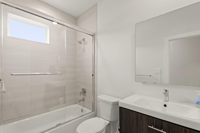 full bathroom featuring bath / shower combo with glass door, vanity, and toilet