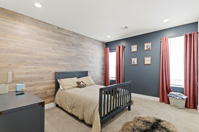 bedroom with recessed lighting, light carpet, wood walls, visible vents, and baseboards