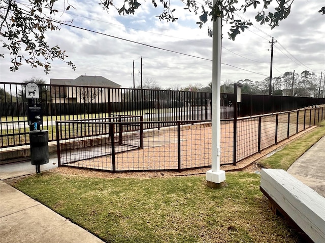 surrounding community with fence and a yard