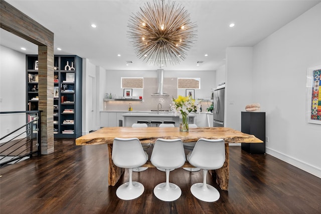 dining area with a chandelier, dark wood-type flooring, baseboards, and recessed lighting