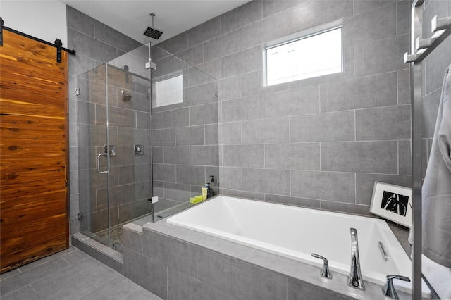 full bath featuring tile patterned flooring, a garden tub, and a shower stall