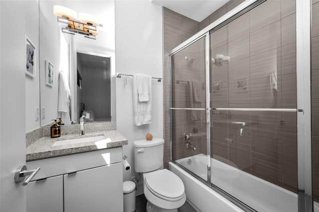 full bathroom with shower / bath combination with glass door, vanity, and toilet