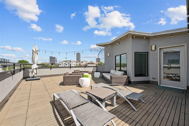 wooden terrace with an outdoor living space and a city view