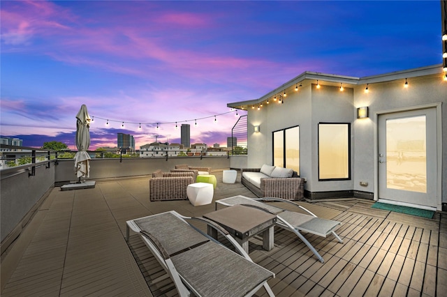 deck at dusk featuring outdoor lounge area