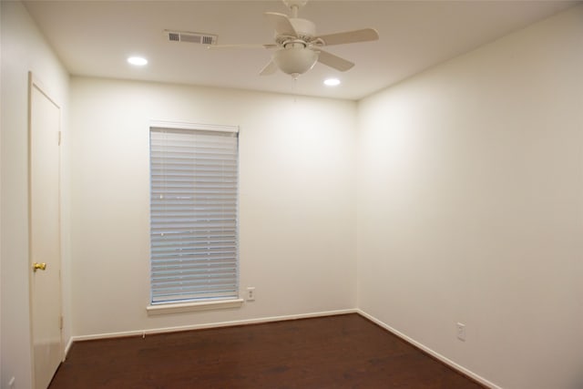 empty room with dark wood-style floors, recessed lighting, visible vents, ceiling fan, and baseboards