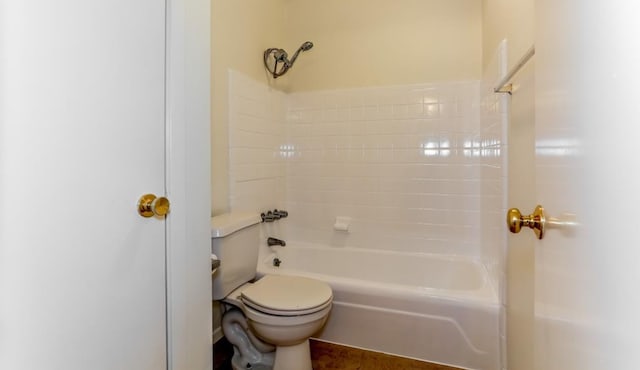 bathroom featuring washtub / shower combination and toilet