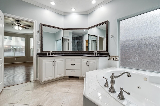 full bath with ornamental molding, a sink, tile patterned flooring, double vanity, and a whirlpool tub