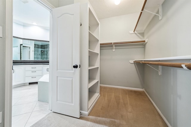 spacious closet featuring light tile patterned floors