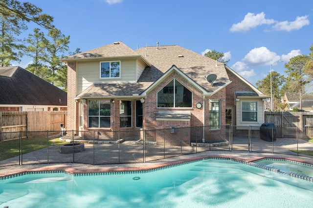 view of pool featuring a fenced backyard, a fenced in pool, an in ground hot tub, and a patio