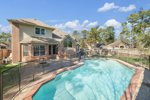 view of swimming pool with a fenced in pool, a fenced backyard, and a patio area