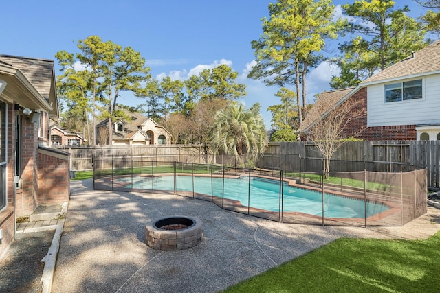 view of swimming pool featuring a fenced backyard, a fenced in pool, and a patio