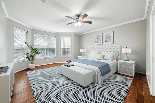 bedroom with a ceiling fan, baseboards, ornamental molding, dark wood-type flooring, and a textured ceiling