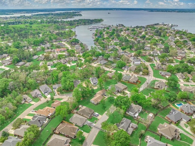 drone / aerial view featuring a residential view and a water view