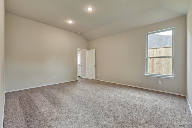 carpeted empty room featuring recessed lighting, baseboards, and lofted ceiling