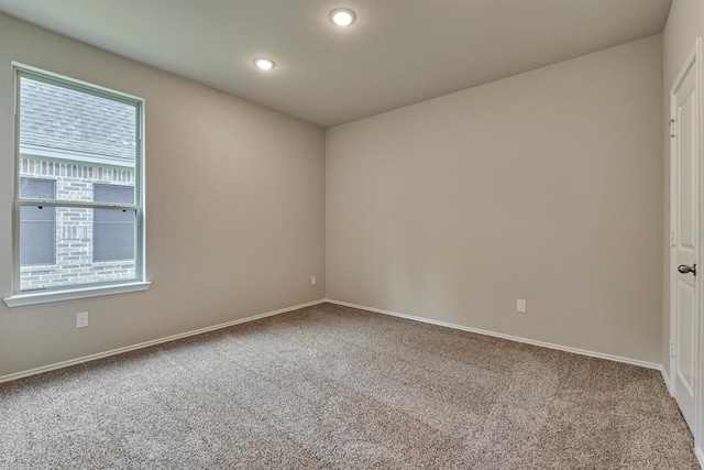 carpeted spare room featuring recessed lighting and baseboards